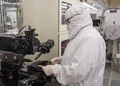Clean room technician Chris Rea takes critical measurements as part of eMagin’s OLED fabrication process.